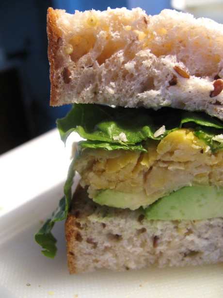 Dijon chickpea sandwich with avocado and spinach on whole grain bread